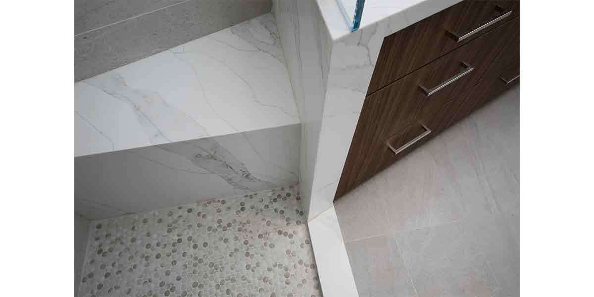 Elegant bathroom vanity with marble countertop and wooden cabinetry.