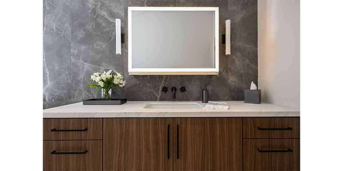 Bathroom vanity with wooden cabinets and large mirror for contemporary interior design.