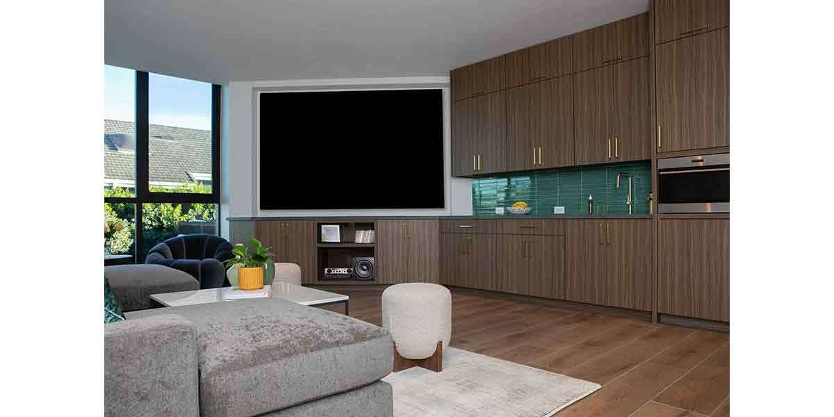Contemporary kitchen and living room interior with sleek cabinetry and large window views.