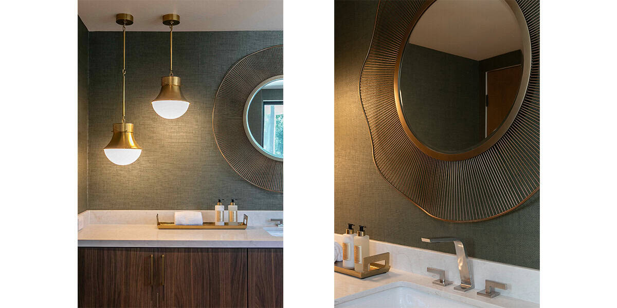 Stylish bathroom vanity with round mirror and modern lighting fixtures.