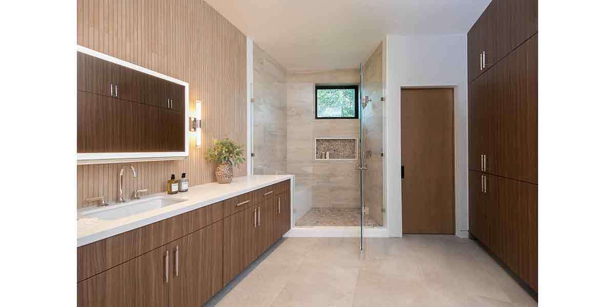 Contemporary bathroom featuring wooden cabinets and a walk-in shower with glass door.