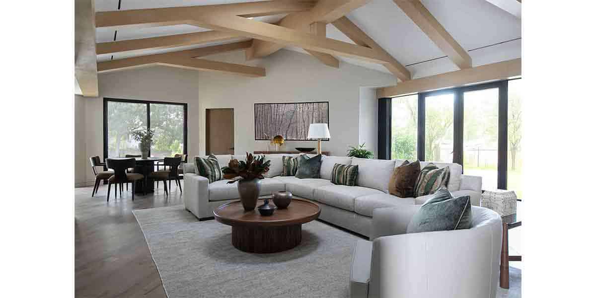 Bright modern living room with large windows and stylish furniture.