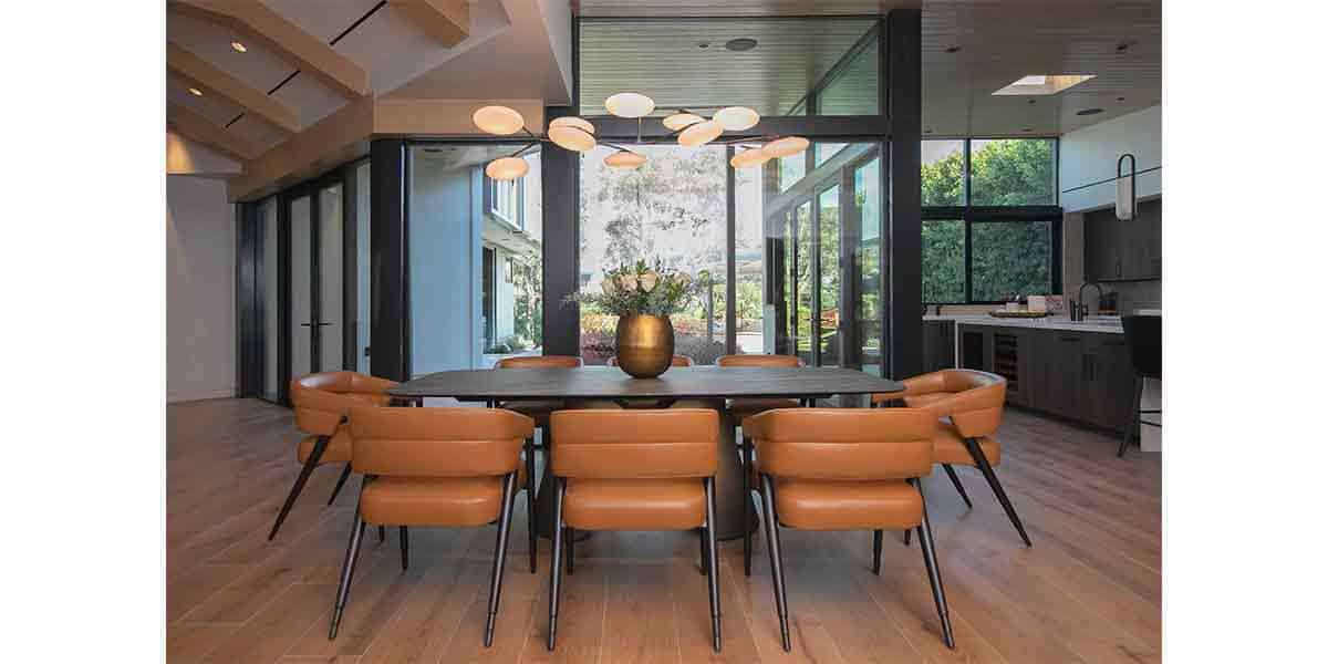Contemporary dining room with large windows, modern furniture, and elegant lighting.