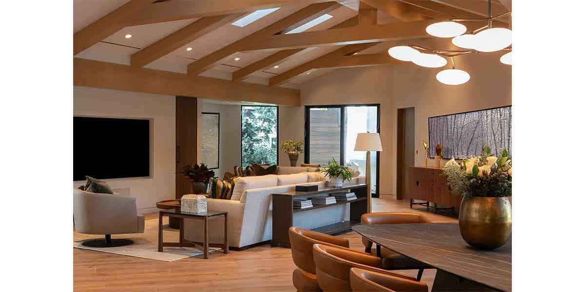 Interior design of a contemporary living room featuring large windows and stylish furniture.