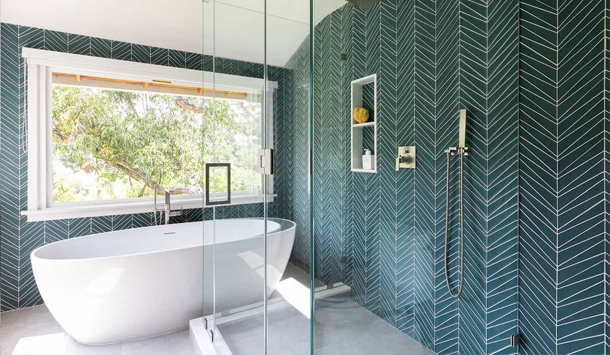 Elegant bathroom featuring a freestanding bathtub and a walk-in shower with sleek fixtures. Bright,.