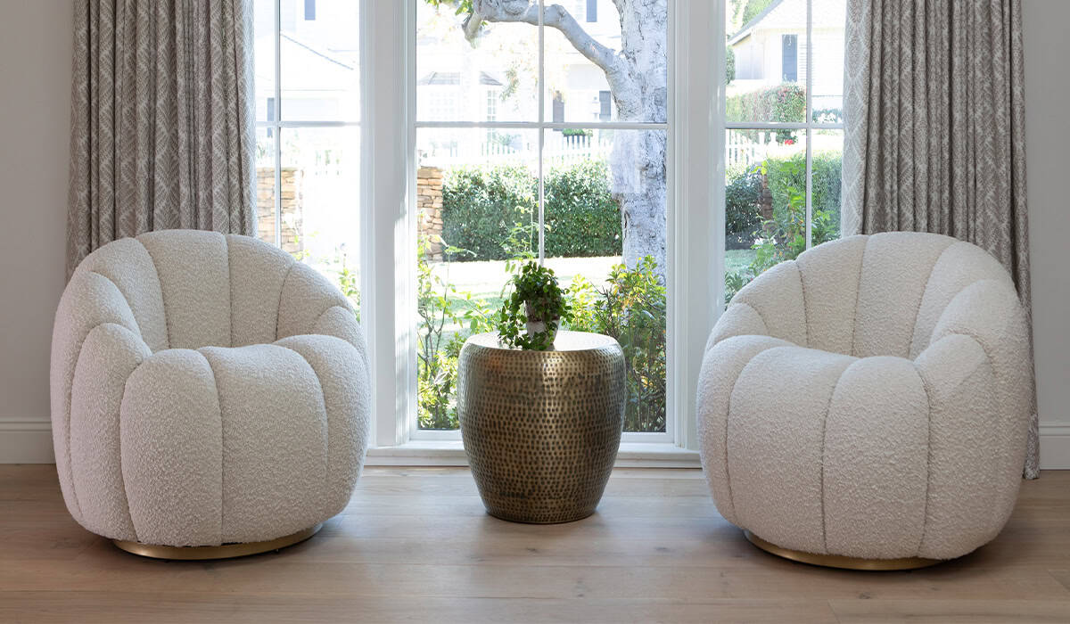 Comfortable modern armchairs with plush fabric in a bright living room setting.