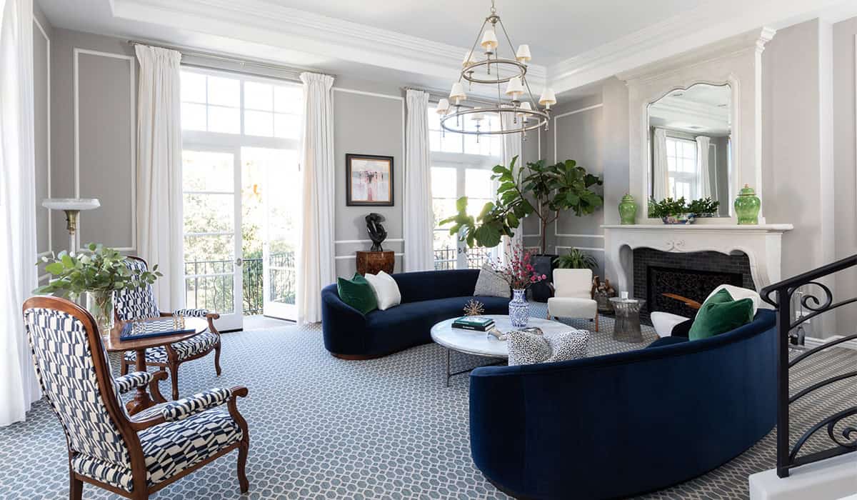 Stylish living room with elegant furniture and decor, bright natural light, and lush greenery.