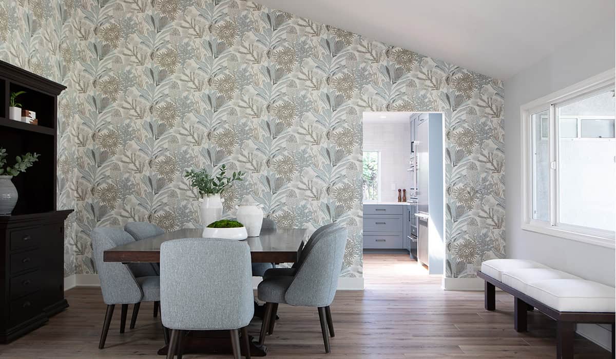 Modern dining room with botanical wallpaper, gray chairs, and natural light from large windows.