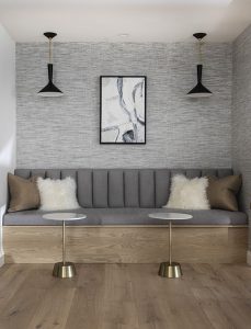 Modern gray sofa with plush accent pillows in a contemporary living room setting.