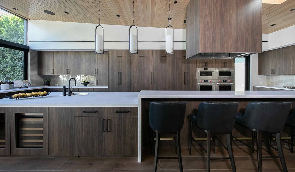 Contemporary kitchen with wood cabinetry and sleek appliances.