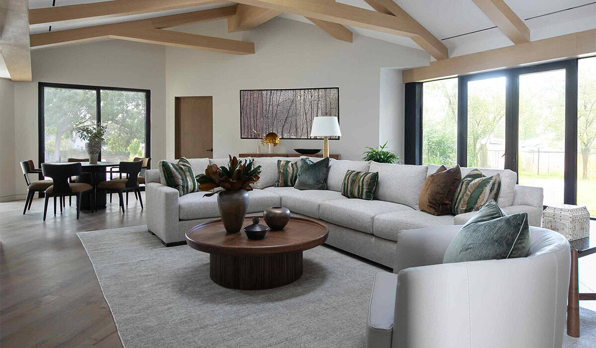 Modern living room with large windows, neutral tones, and stylish furniture for a cozy, elegant spac.